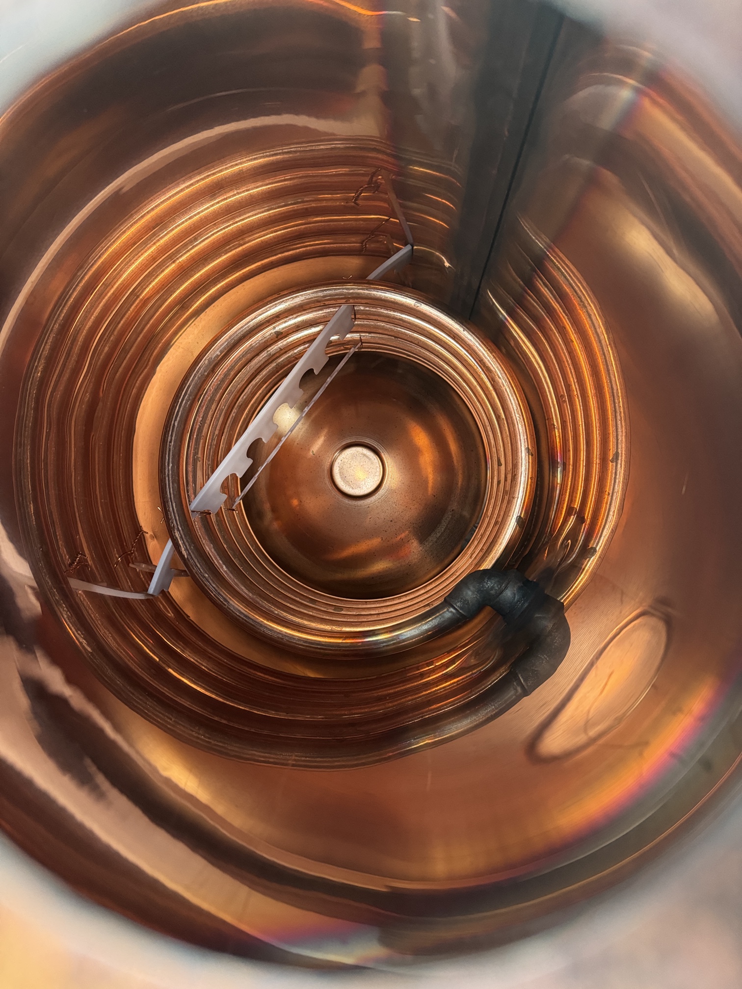 Internal view of copper coil in hot water cylinder showing traditional heating element